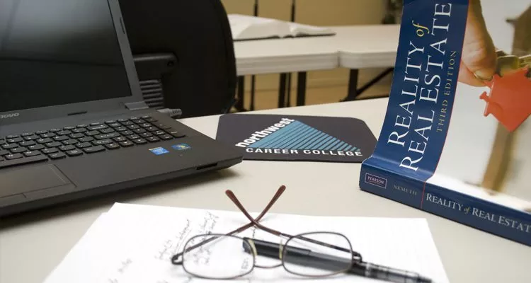 Picture of glasses and pen on top of notepad