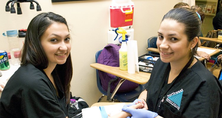 Two phlebotomy students smiling