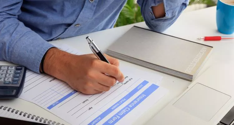 Man preparing an health Insurance Claim Form