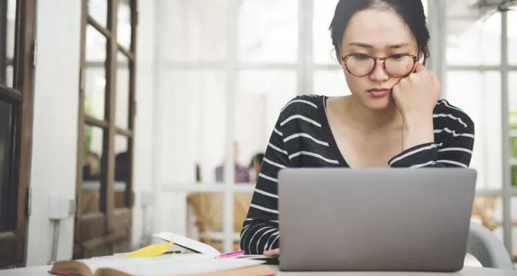 Young woman looking at her computer