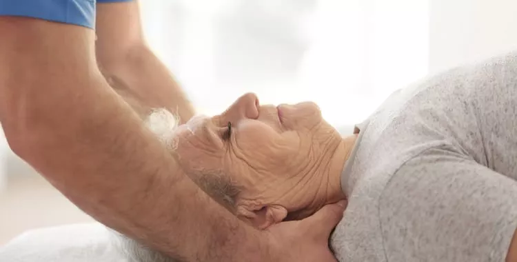 Old woman receiving hospice care massage therapy