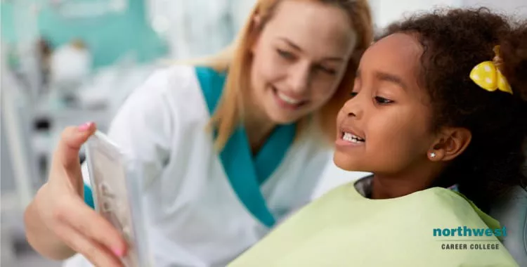 A Dental Assistant showing mirror to her patient