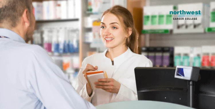 A woman pharmacy technician talking with a man