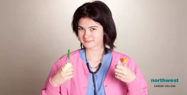 A phlebotomist holding test tubes