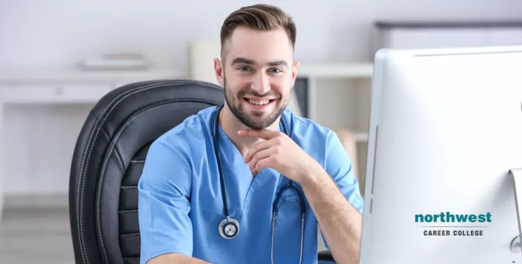a medical assistant working on his desk