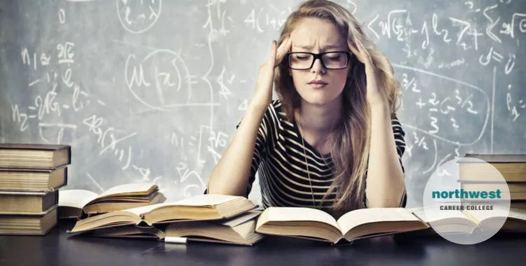 A young girl is studying but is very stressed out.