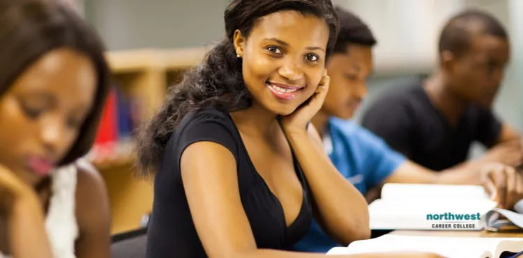 Picture of a woman in black dress in class.