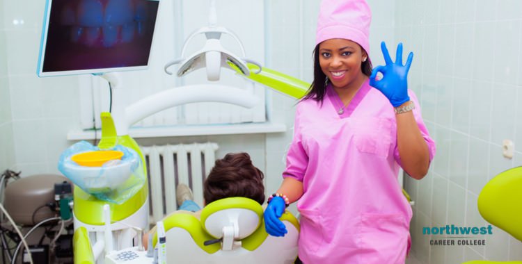 An American Dental Assistant giving the "all-okay" sign.