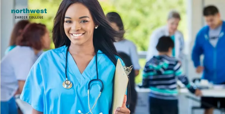 A female healthcare person with stethoscope around her neck and clipboard in her hand.