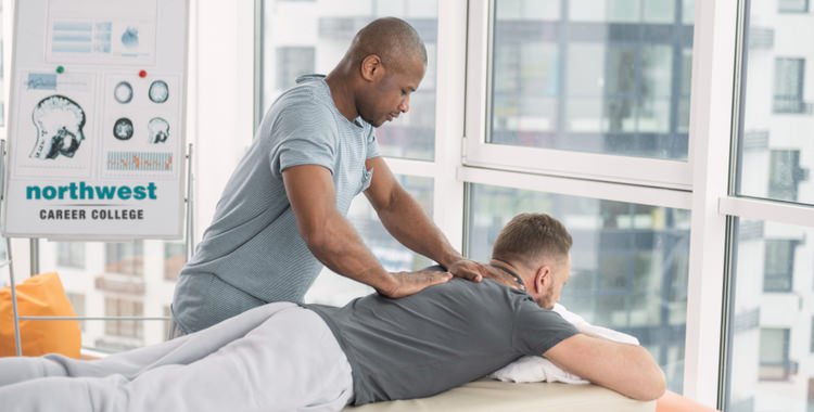 A man is giving massage therapy to another man.