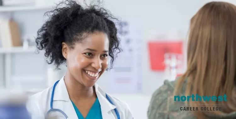 A female Medical Assistant taking patient history