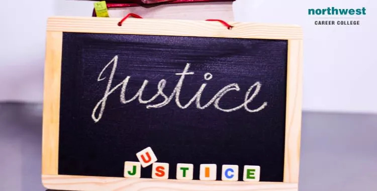 The word Justice written on a slate.