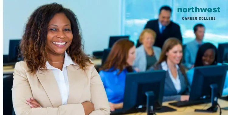 A female professor standing proud before her class and wearing a boastful smile.