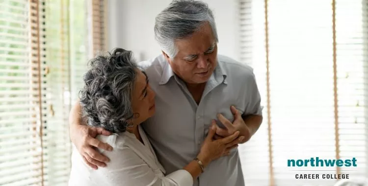 A senior male is having a sudden heart attack while his wife is in his embrace.