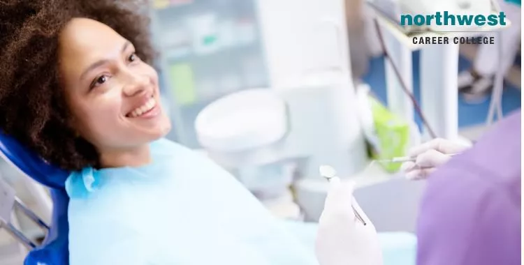 A woman looking at her dentist and smiling as she is about to undergo dental procedure.