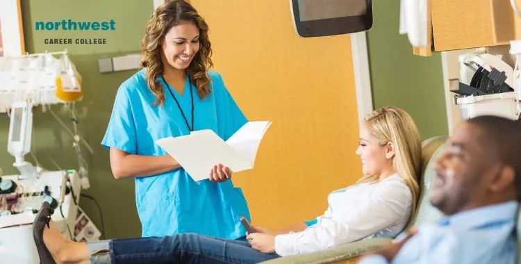 A female phlebotomy technician writing information taken from a patient.