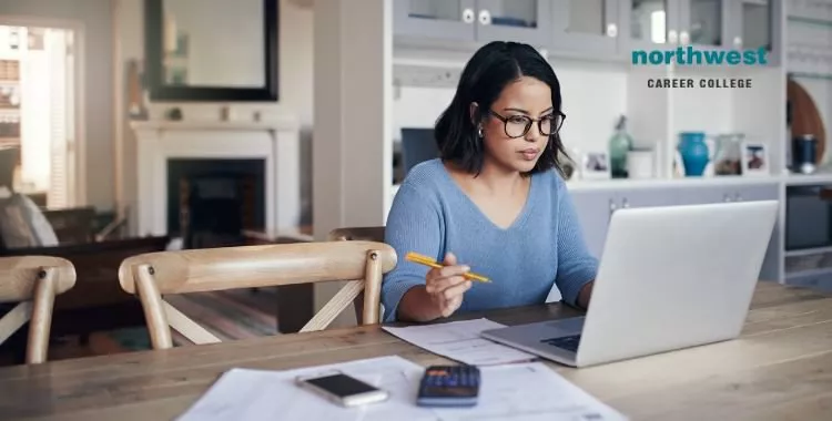 A working woman who is studying from home.