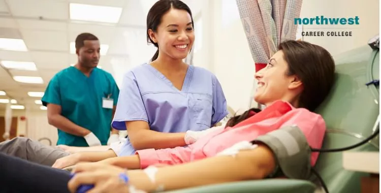 Phlebotomy technician talking with blood donors who was making a blood donation.