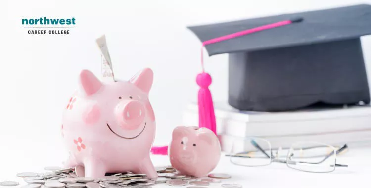 A piggy bank on top of coins with glasses and graduation cap in the background.