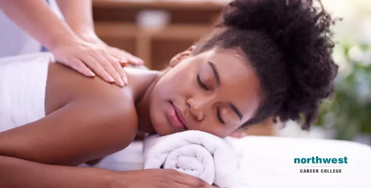 A woman taking massage therapy from a masseuse.