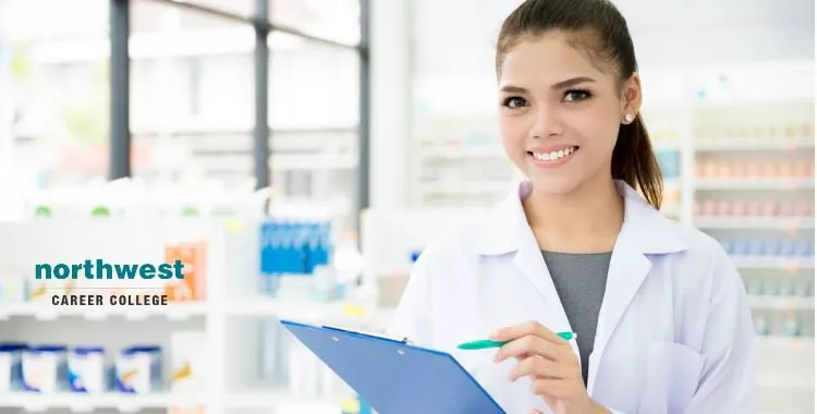 pharmacy technician with a clipboard and pen in hand working in pharmacy