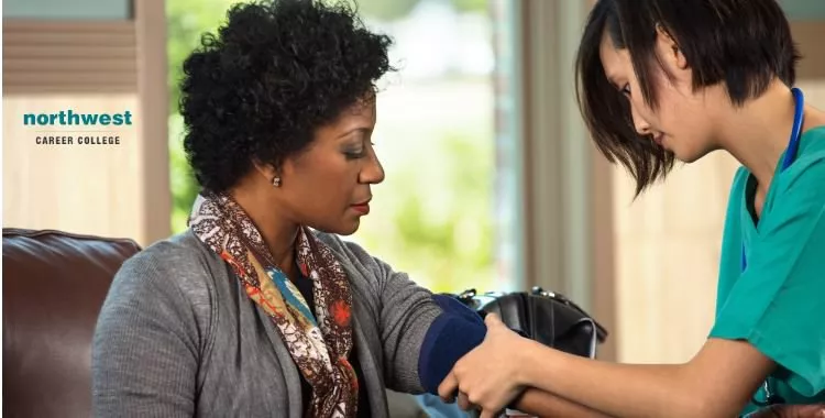 A medical assistant measuring blood pressure of a patient