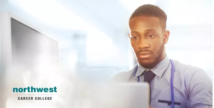 medical coder working at his desk