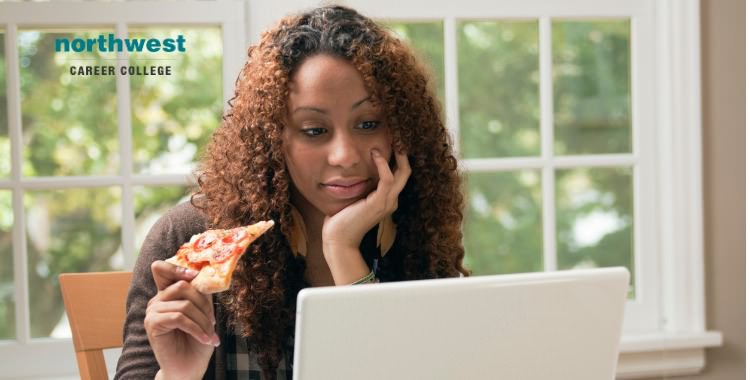 student studying and eating pizza