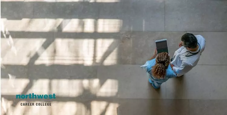 medical-assistant-and-doctor on tablet at the hospital