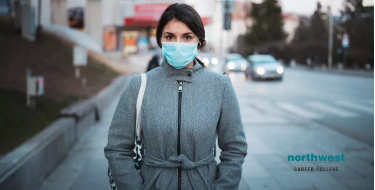 young woman with face mask on the street