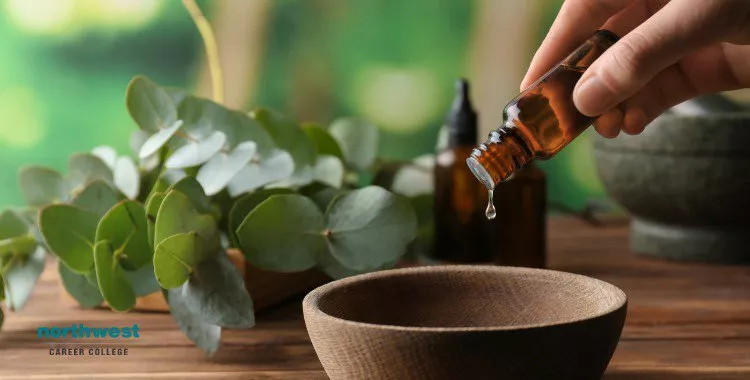 essential oils into bowl on wooden table