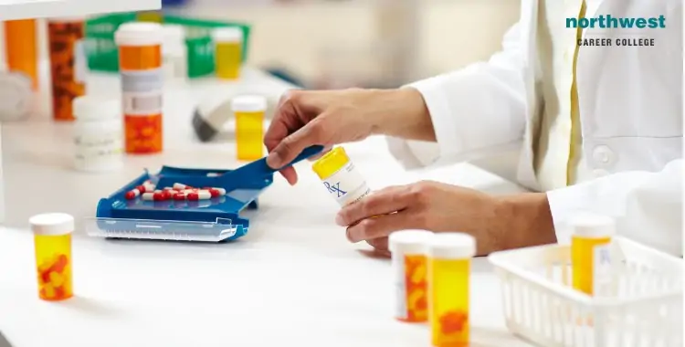 A pharmacist measures pills with a scale in a pharmacy, surrounded by various prescription bottles.