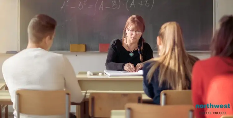 A teacher explains concepts to students, highlighting the pressure of Exam Stress in a classroom setting.