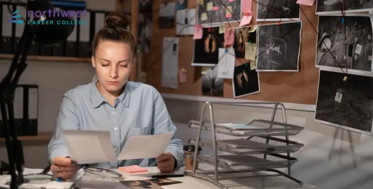 A student studies evidence and notes, preparing for a career with a Degree in Criminal Justice at Northwest Career College.