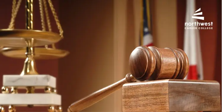 A wooden gavel rests on a block, with a scale of justice in the background and a logo for Northwest Career College.