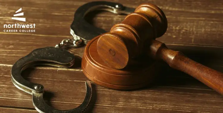 A wooden gavel and handcuffs on a wooden surface, with the logo of Northwest Career College in the corner.