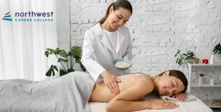 A therapist applies a treatment to a clients back in a serene spa setting.