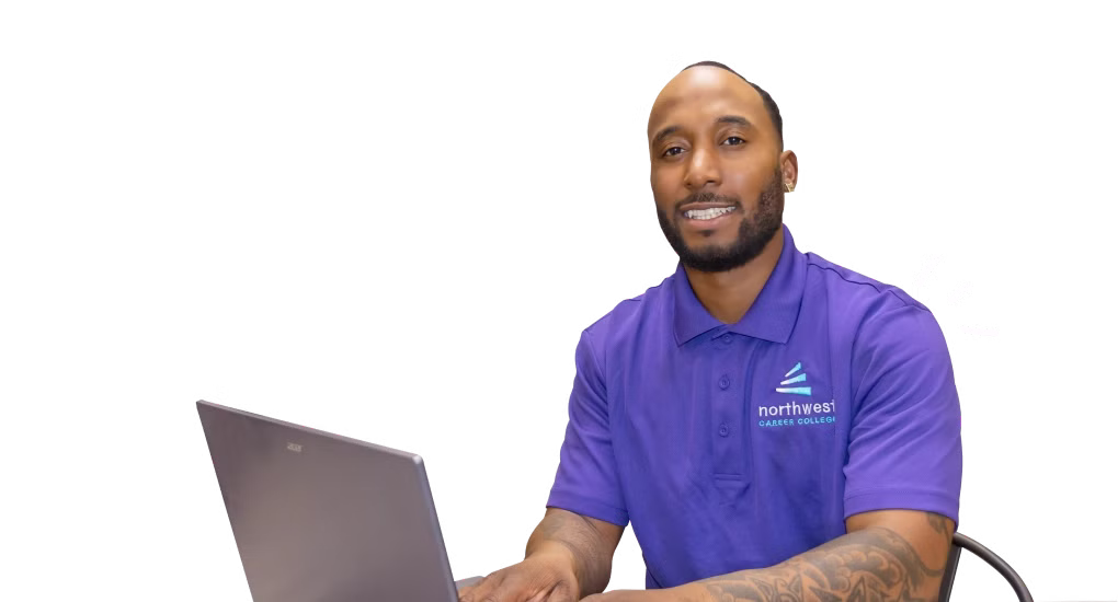 A man in a purple polo sits at a laptop, promoting a business administration degree at Northwest Career College.