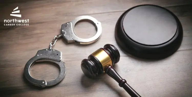 A gavel, wooden block, and handcuffs on a wooden surface, with a logo for Northwest Career College in the corner.