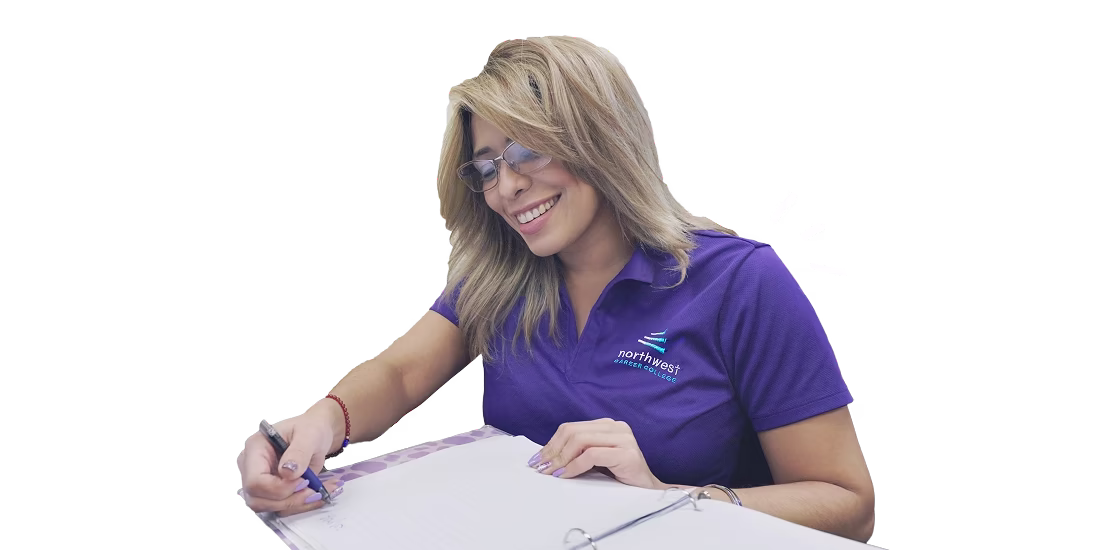 A student in a purple shirt smiles while taking notes, representing a positive atmosphere at paralegal school.