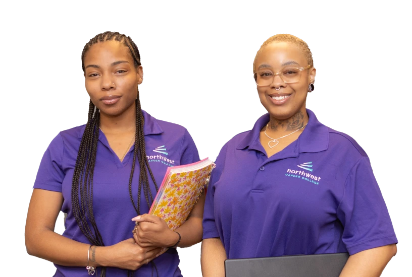 Two business administrative assistant diploma program students pose together, smiling, wearing matching purple polo shirts.