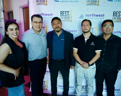 Northwest Career College Paralegal studies students at graduation day, posing with faculty in front of a branded backdrop.