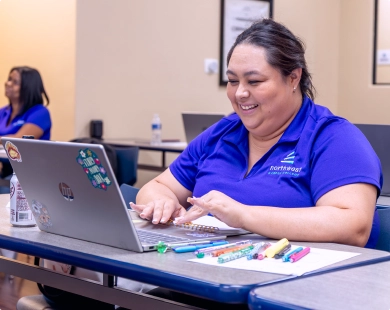 A student engaged in paralegal studies hands-on training in Las Vegas, Nevada, using a laptop and colorful pens.