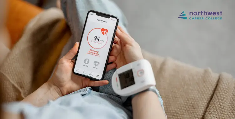 Person checking heart rate on a smartphone while wearing a blood pressure monitor on their wrist.