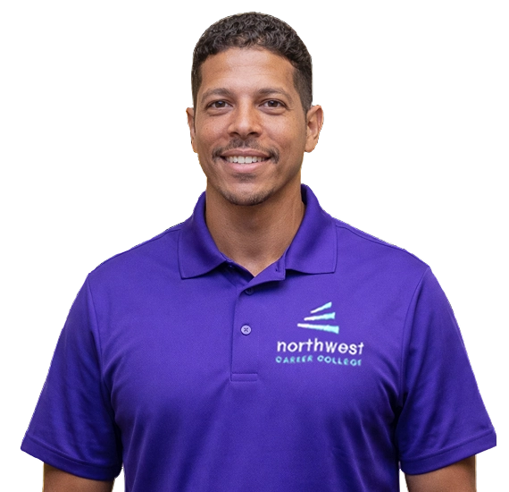 Smiling man in a purple polo shirt with Northwest Career College logo, standing against a plain background.