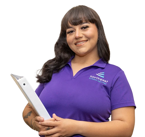 Smiling woman in a purple polo holds a clipboard, representing legal assistant school Las Vegas at Northwest Career College.