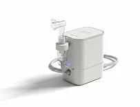 A compact nebulizer with a clear mouthpiece and tubing, designed for respiratory treatments.