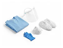 A set of PPE including a blue gown, gloves, face shield, mask, and shoe covers arranged neatly.
