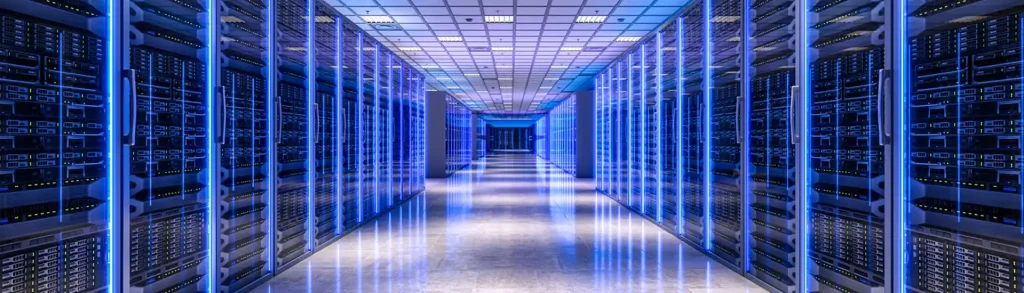 A futuristic data center hallway lined with illuminated server racks and reflective floors.